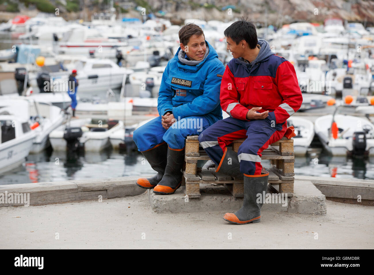 Young men at the harbor, Ilulissat, Greenland Stock Photo
