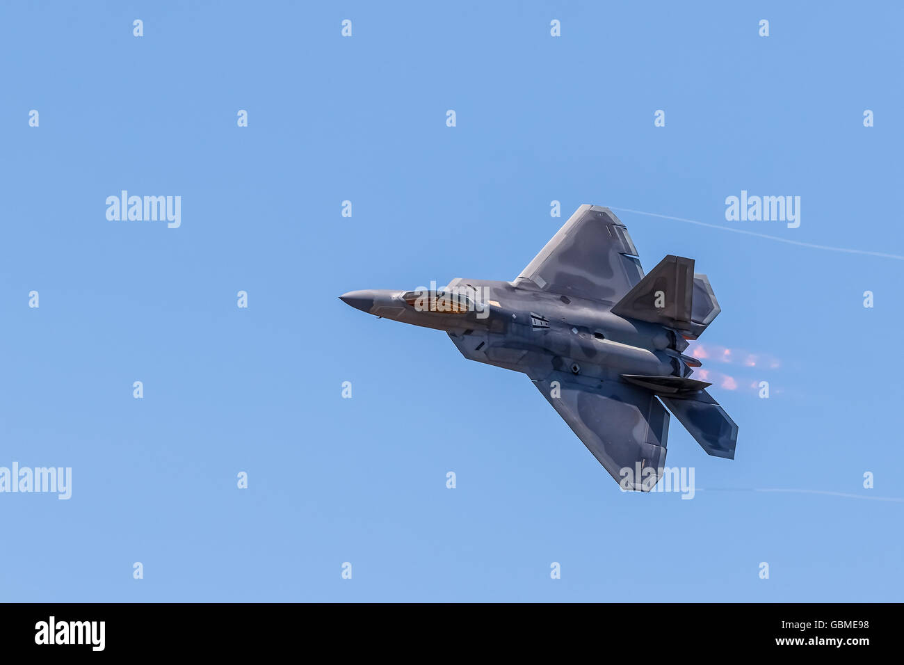 F-22 Raptor in flight with vapor clouds along the leading edges Stock Photo