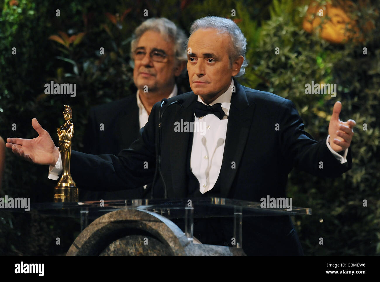 Spanish tenor Jose Carreras (R) stands next to opera singer Placido Domingo (L) as he makes a speech after receiving a Lifetime Achievement Award from the Duchess of Cornwall, during the Classical Brit Awards at the Royal Albert Hall in London. Stock Photo