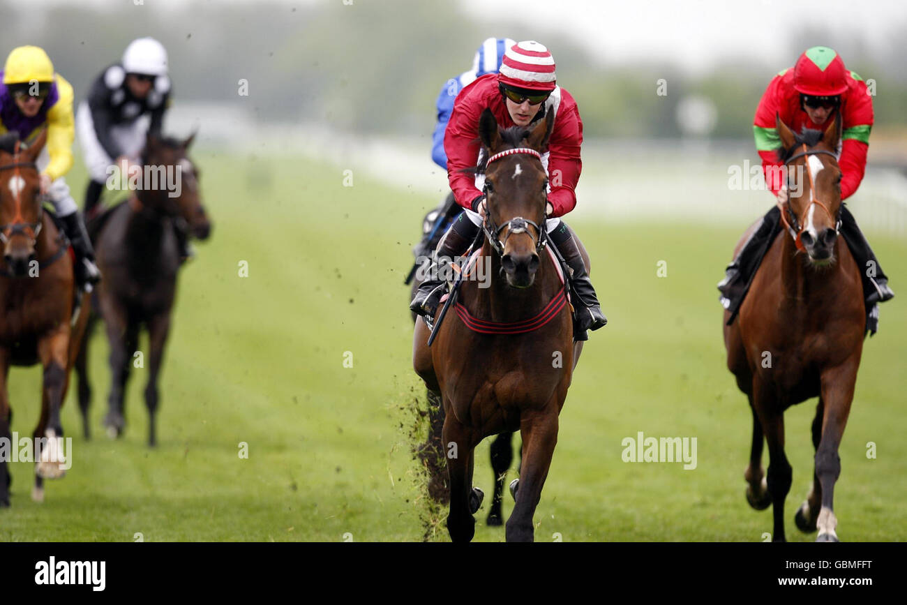 Apple Charlotte ridden by jockey Tom Queally (centre) go on to win Swettenham Stud Fillies Trial Stakes at Newbury Racecourse, Berkshire. Stock Photo