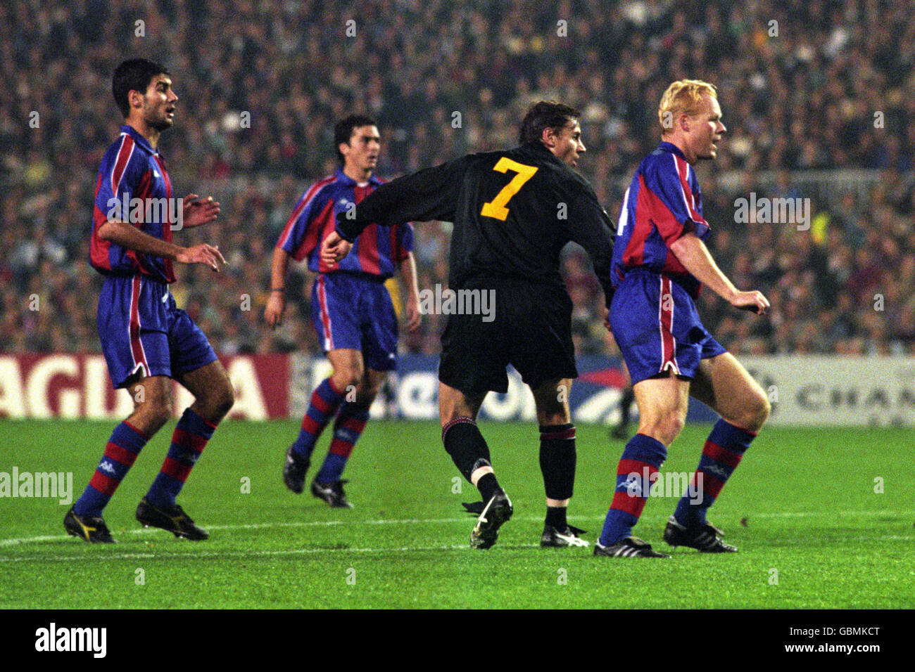 Barcelona's Josep Guardiola (l) and Ronald Koeman (r) look on as Manchester United's Andrei Kanchelskis (c) shoots on goal Stock Photo