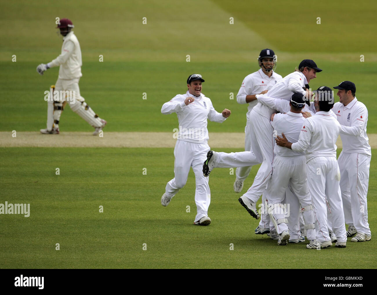 England's Graeme Swann celebrates with teammates after taking the wicket of Shivnarine Chanderpaul for a golden duck during the First npower Test match at Lord's Cricket Ground, London. Stock Photo
