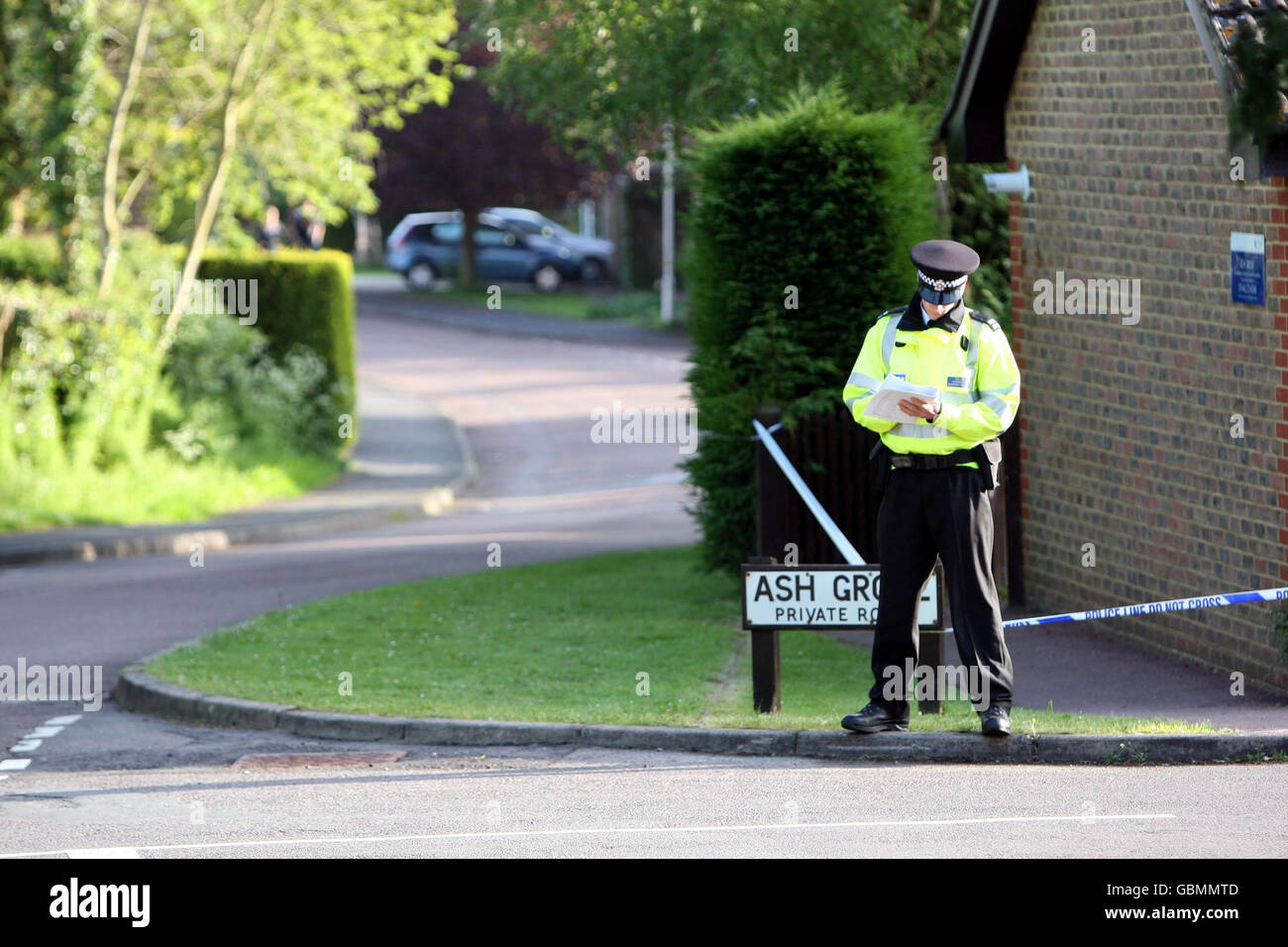 A police officer stands outside Ash Grove in Fernhurst, West Sussex