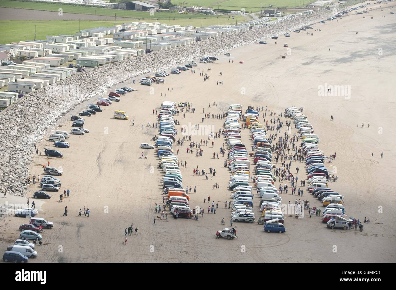 Photo. Volkswagen enthusiasts gather together in fine weather on the beach at Brean Down, as part of VanWest in Somerset. Stock Photo