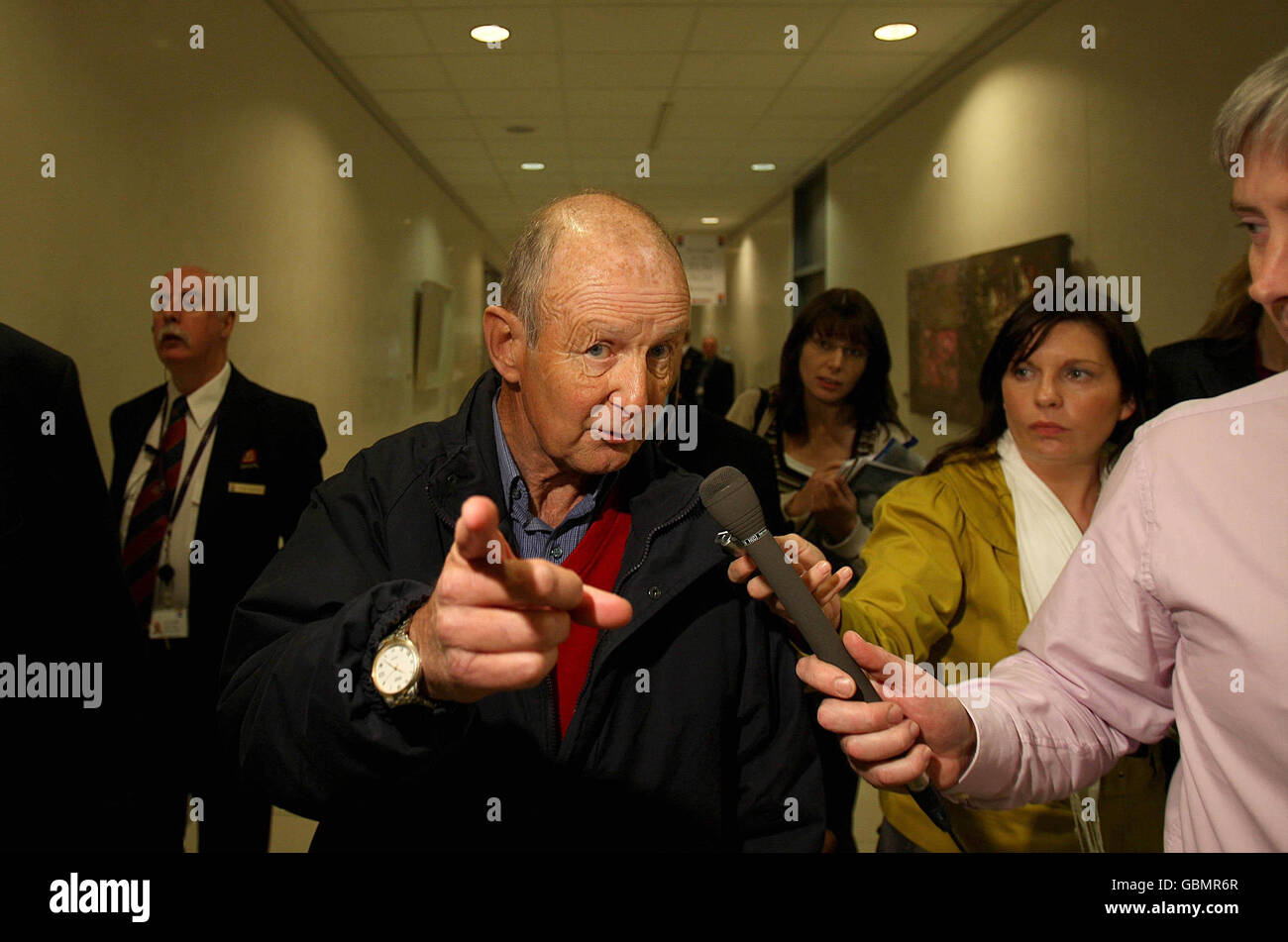 Protester Gary Keogh from Blackrock is interviewed by media as he is escorted from Ailled Irish Banks Headquarters in Ballsbridge Dublin. Shareholders packed Allied's banking centre for an EGM, where they will later vote to ratify the Government's 3.5 billion euro (3.1 billion) recapitalisation plan. Stock Photo