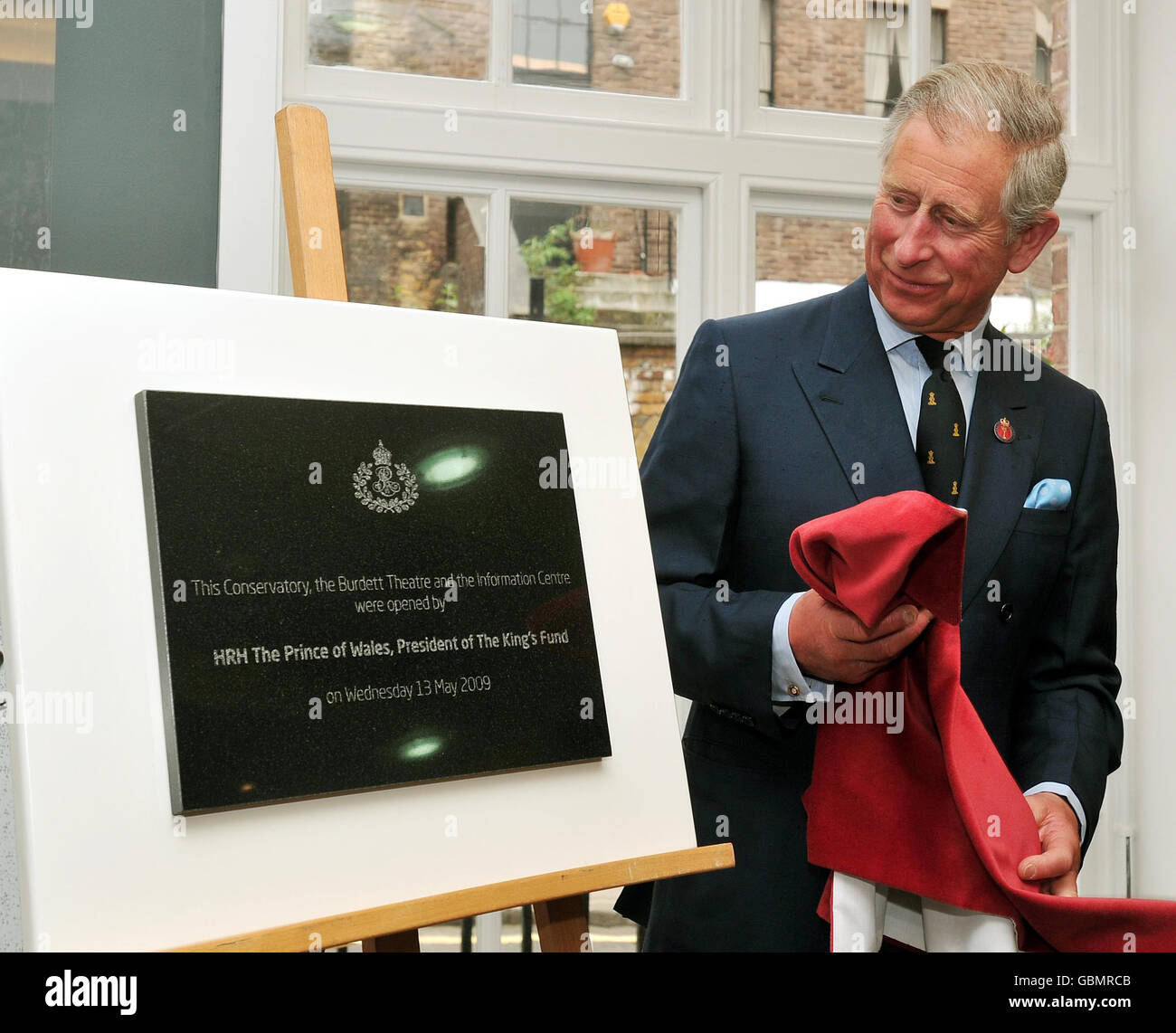 The Prince of Wales unveils a plaque at the opening of the renovated Conservatory, Burdett Theatre and the Information centre at the King's Fund offices in central London. Stock Photo