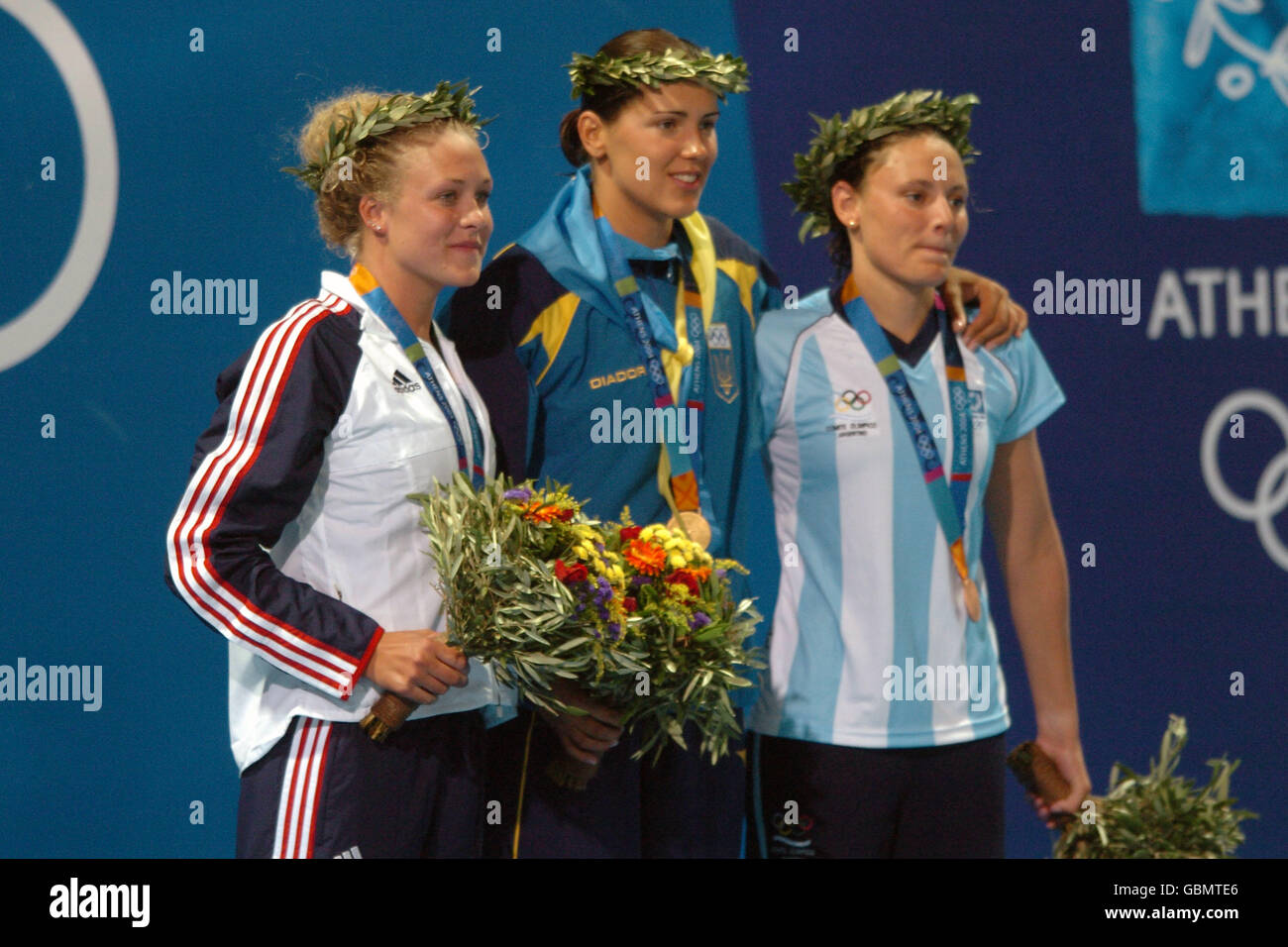 (L-R) USA's Kaitlin Sandeno (silver), Ukraine's Yana Klochkova (gold) and Argentina's Georgina Bardach (bronze) pose for photos after recieving their medals Stock Photo
