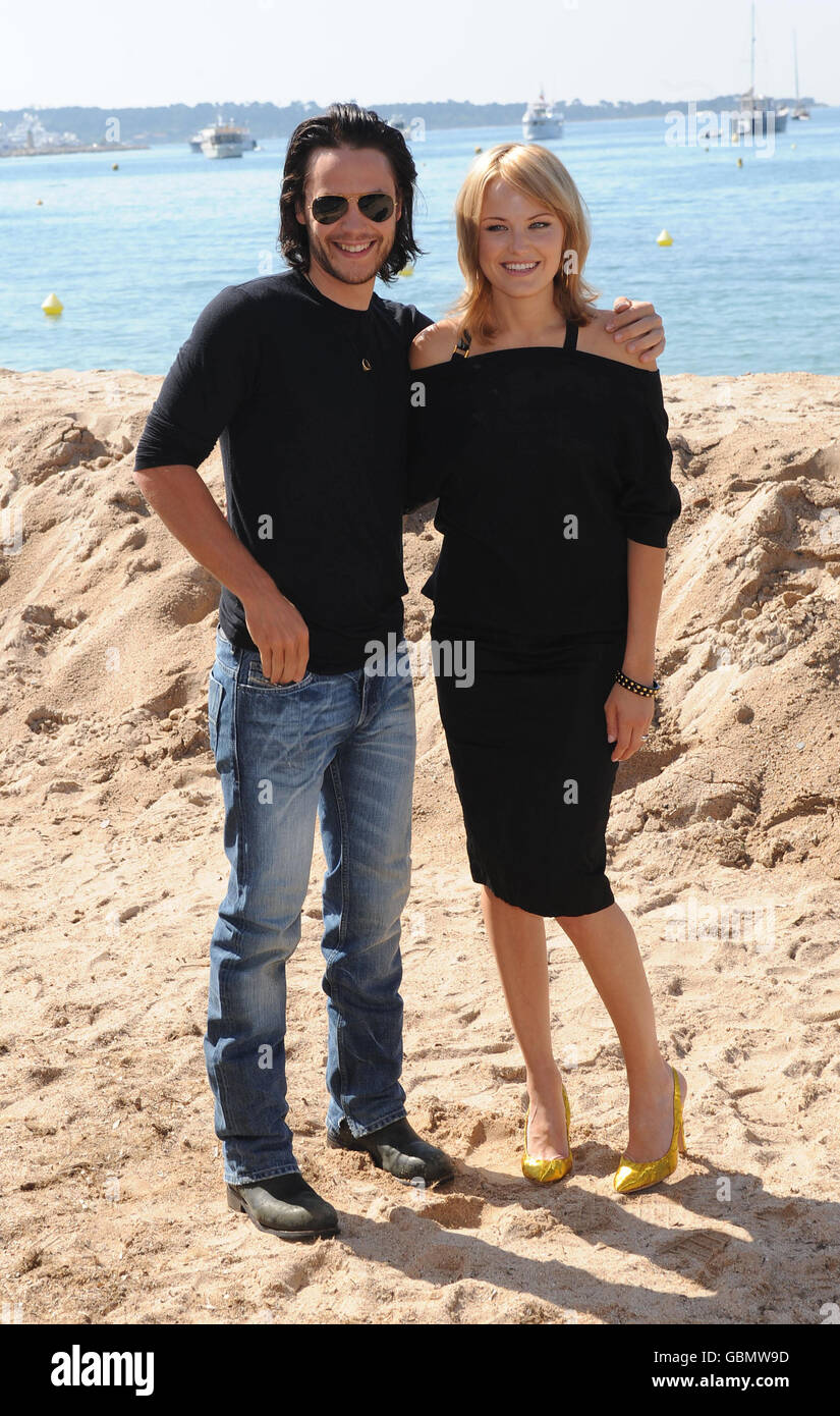 Taylor Kitsch and Malin Akerman, during a photocall for the film, The Bang Bang Club, on the Gray D'Albion beach in Cannes, France, as part of the 62nd annual Cannes Film Festival. Stock Photo