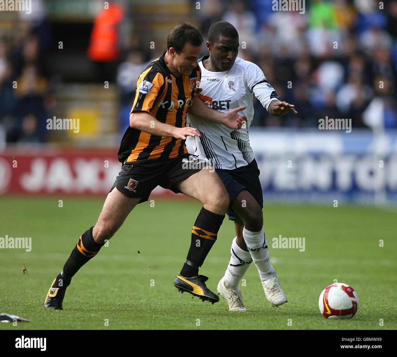 Bolton Wanderers' Jlloyd Samuel (right) and Hull City's Richard Garcia battle for the ball Stock Photo