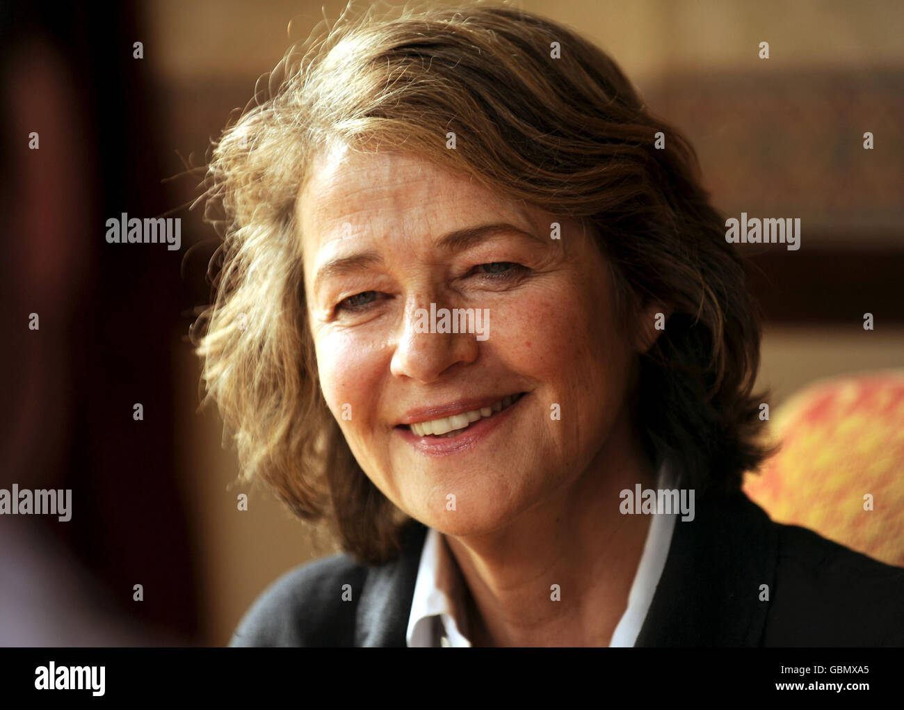 Actress Charlotte Rampling speaks to the media as her father Godfrey Rampling who is Britain's oldest Olympian celebrates his 100th Birthday during a party at Bushey House, Bushey. Stock Photo