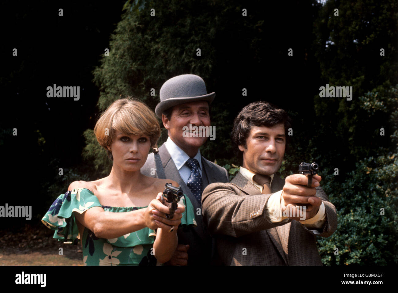 (L-R) Joanna Lumley, who plays Purdey, Patrick MacNee, who plays John Steed, and Gareth Hunt, who plays Mike Gambit, pictured during filming at Pinewood Studios Stock Photo