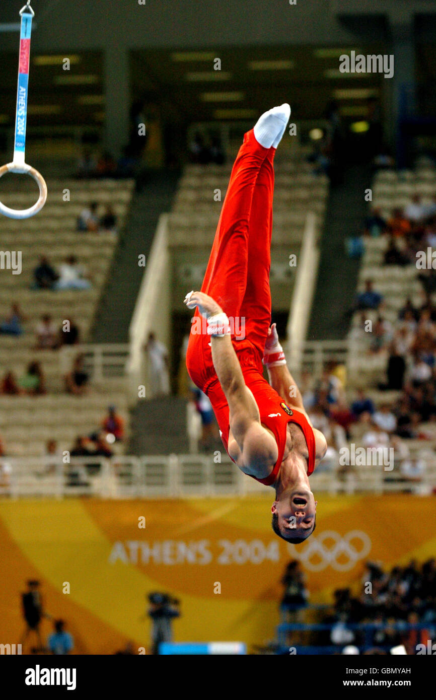 Gymnastics - Athens Olympic Games 2004 - Men's Team Final. Romania's Marian Dragulescu as he dismounts from the rings Stock Photo