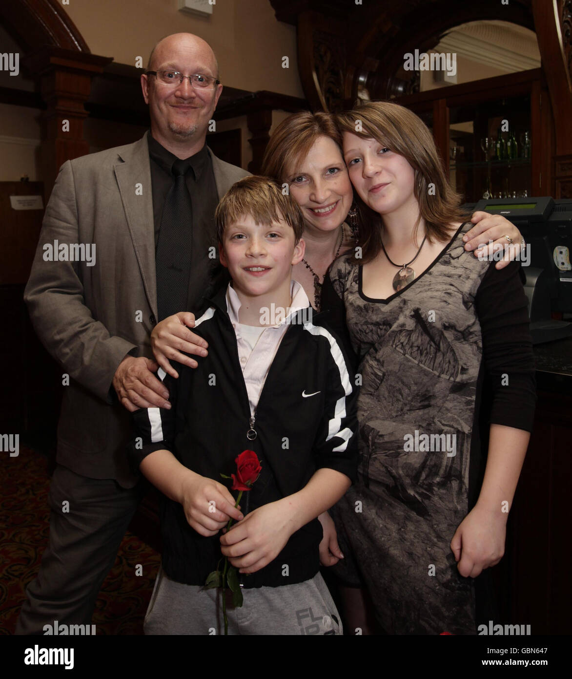 Ollie Gardner, 12, (centre) with his father Simon, mother Sabra and sister Stanya celebrate the fourth birthday (and 1700th performance) of Billy Elliot The Musical, at the Victoria Palace Theatre in central London. Stock Photo