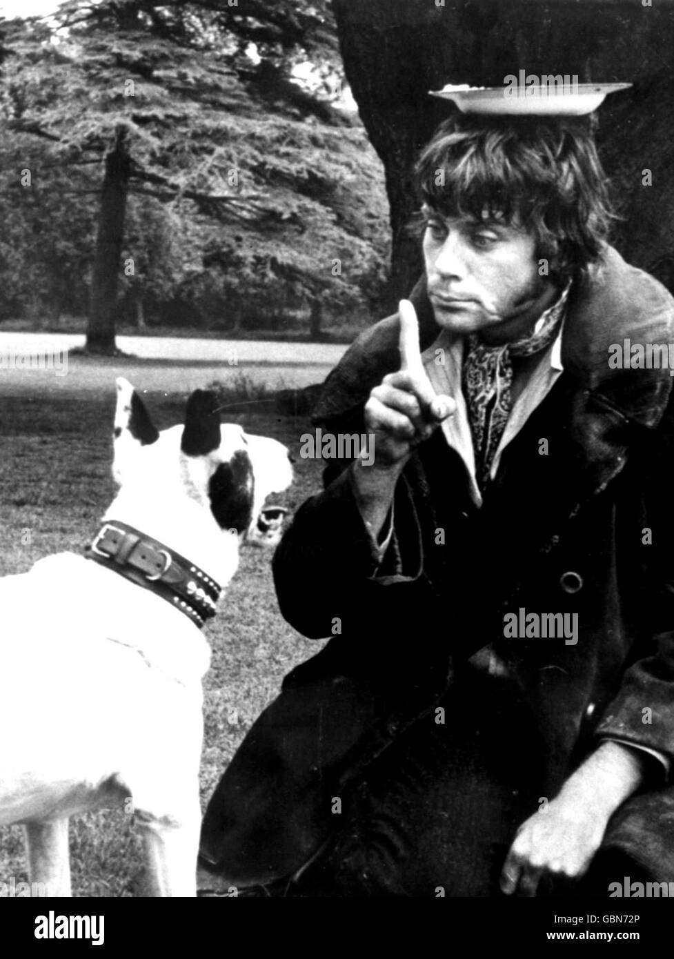 Oliver Reed, who plays Bill Sikes, plays around with one of his co-stars during a break in filming. Stock Photo