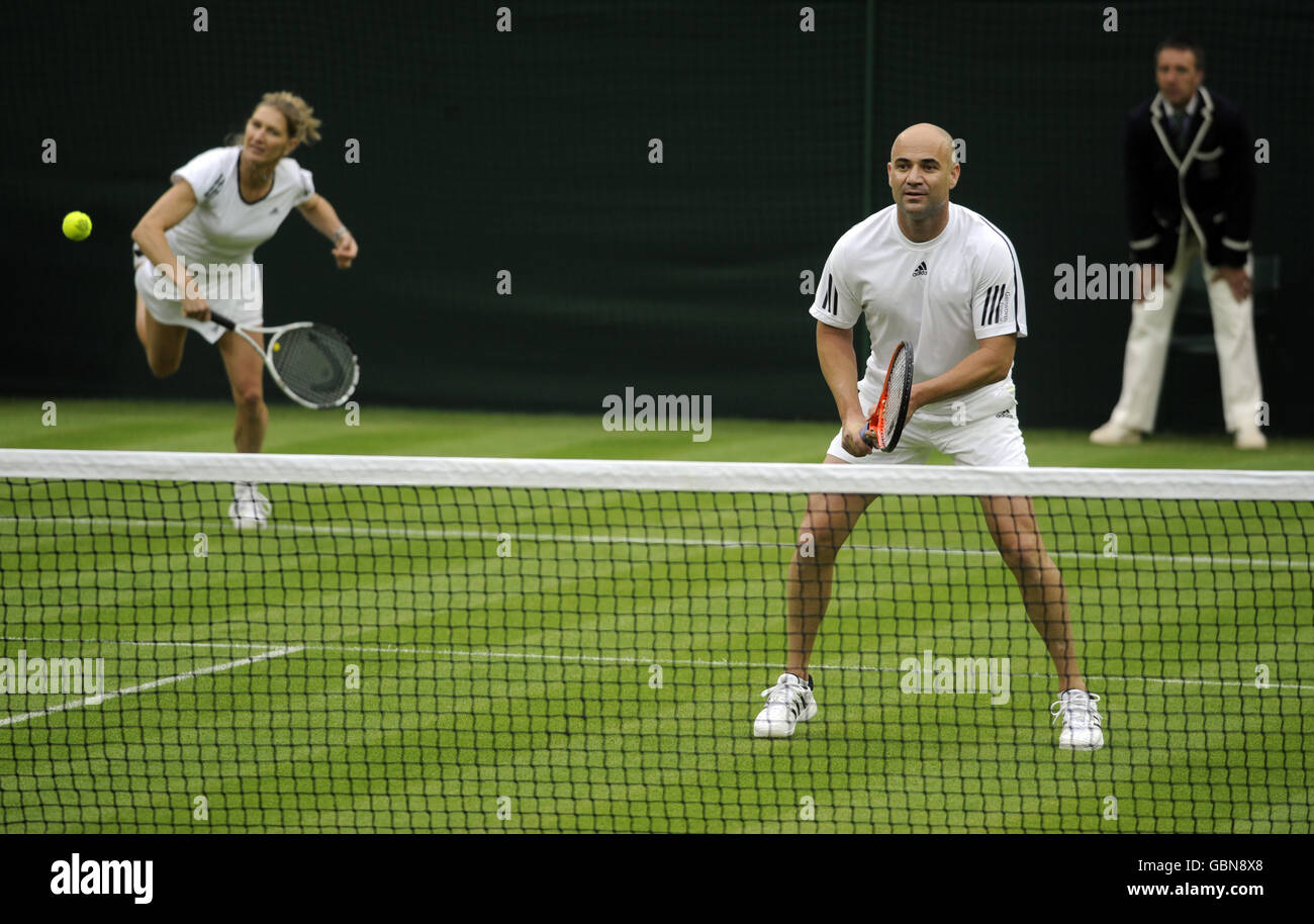 Former Wimbledon champion Steffi Graf (left) in action with her partner and husband Andre Agassi against Great Britain's Tim Henman and Kim Clijsters on centre court, during the Centre Court Celebration at The All England Lawn Tennis and Croquet Club, Wimbledon, London. Stock Photo
