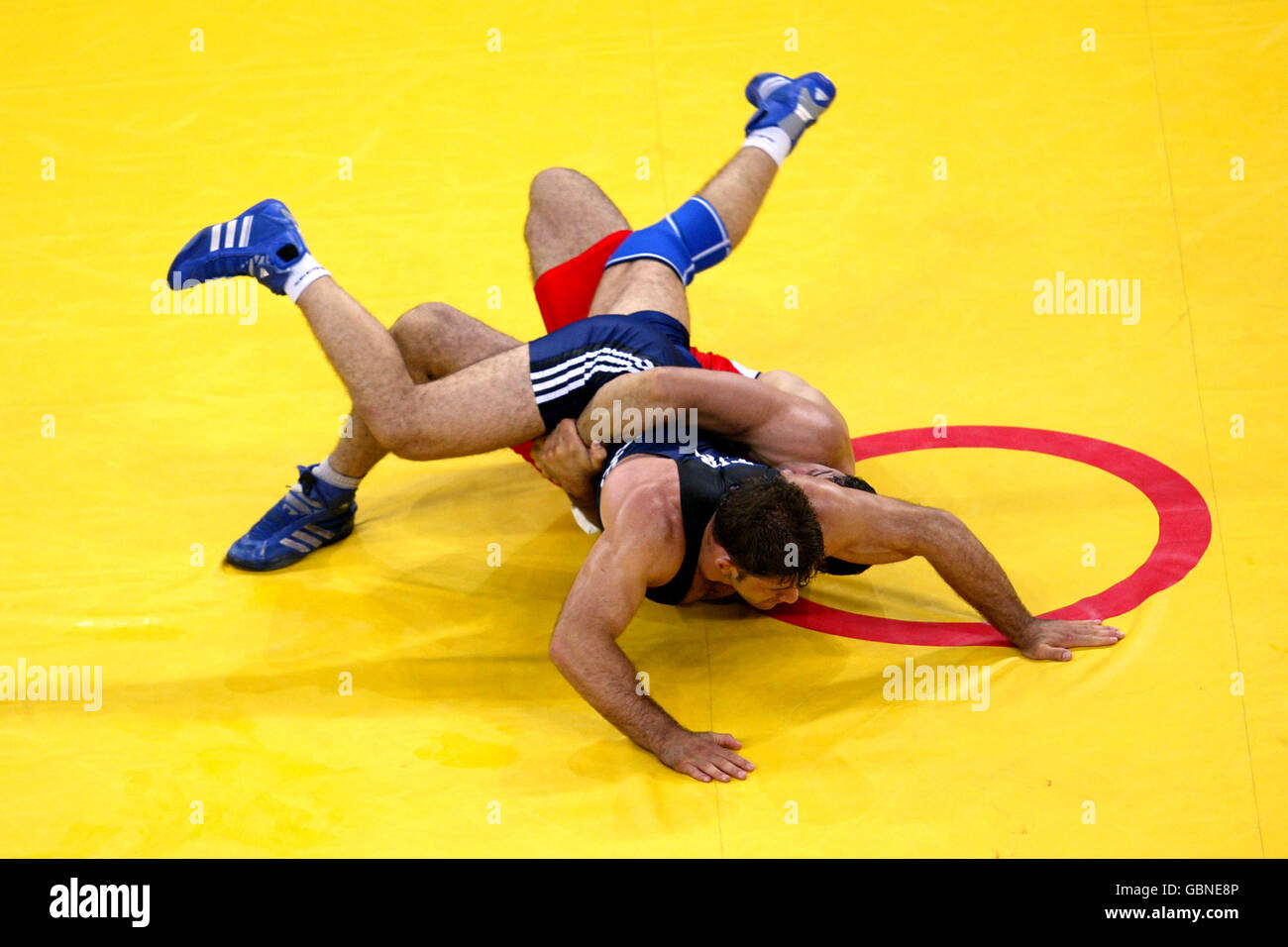 Iran's Masoud Hashemzadeh (red) and Turkey's Mehmet Ozal (blue) battle for the bronze medal Stock Photo