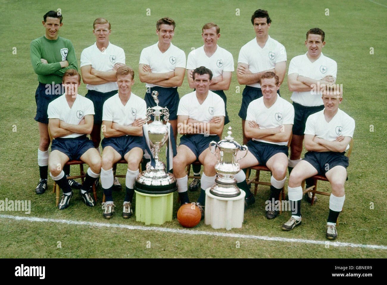 The Tottenham Hotspur first team pose with the League Championship trophy and FA Cup, both of which they won in 1960-61 to become the first 20th Century team to win the Double: (back row, l-r) Bill Brown, Peter Baker, Ron Henry, Danny Blanchflower, Maurice Norman, Dave Mackay; (front row, l-r) Cliff Jones, John White, Bobby Smith, Les Allen, Terry Dyson Stock Photo