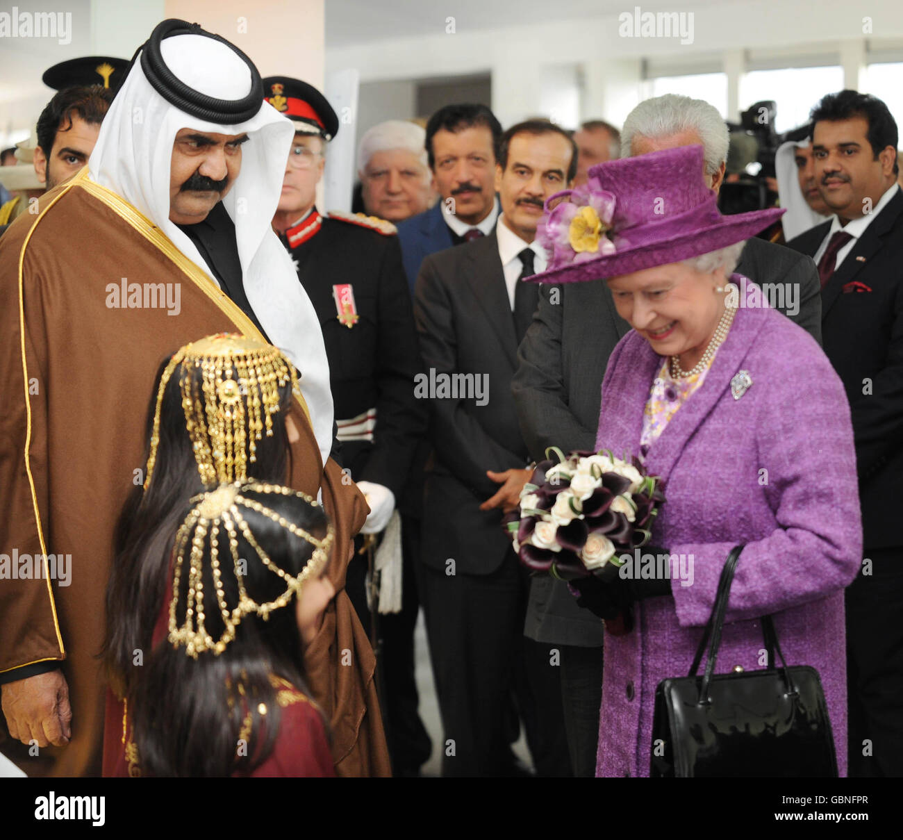 Britain's Queen Elizabeth II speaks with children and The Amir of Qatar at the official inauguration of the South Hook Liquefied Natural Gas (LNG) Terminal in Milford Haven. Stock Photo