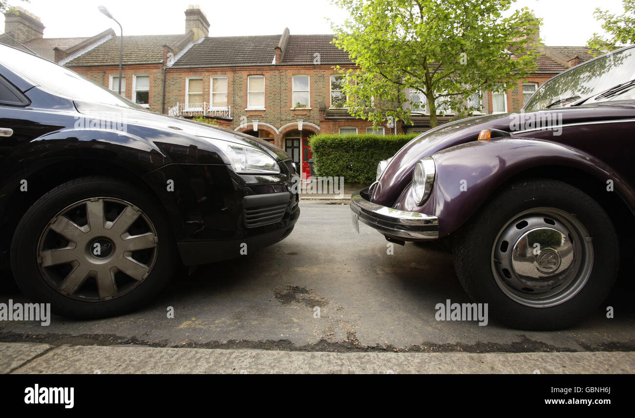 An old VW Beetle car (right) parked next to a new Ford Focus in east London as Business Secretary Lord Mandelson today hailed the 'cash for bangers' car-scrappage scheme as a 'wonderful bargain' for motorists. Stock Photo