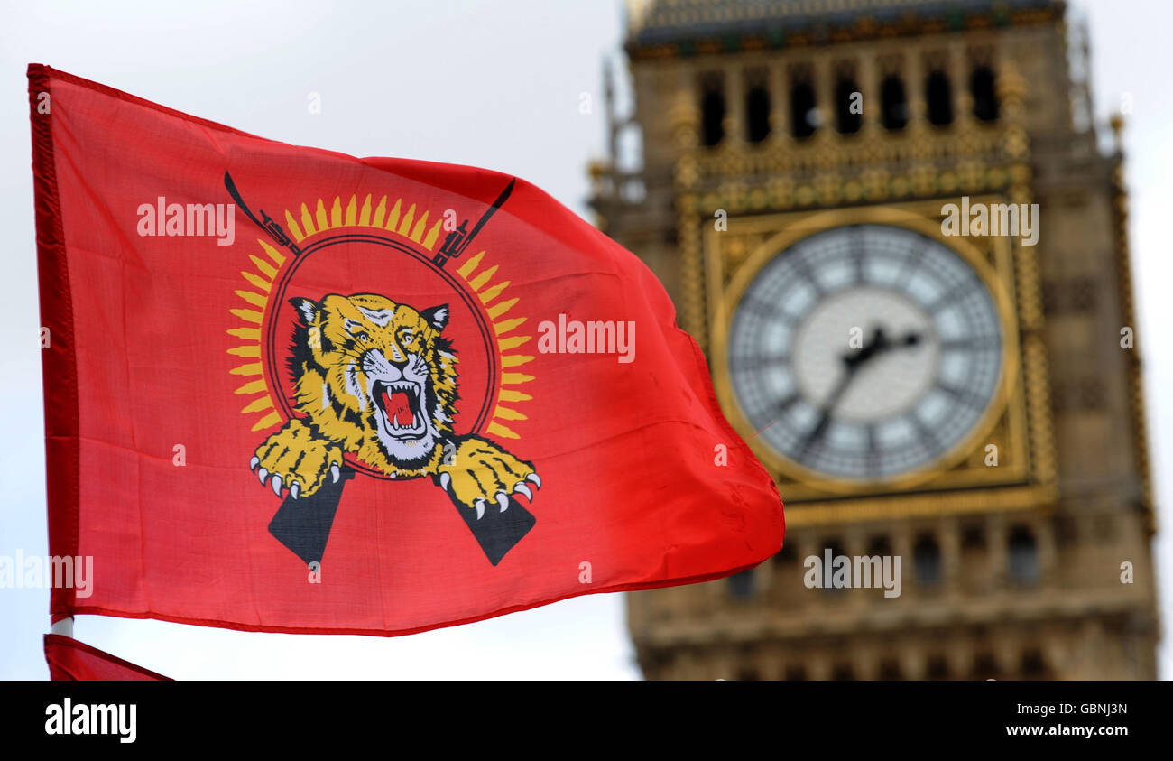 A Tamil Tiger flag flies in front of the Houses of Parliament as Tamil supporters demonstrate on Parliament Square, following news that the leader of Sri Lanka's rebel Tamil Tigers was killed by army troops today, crushing their final resistance. Stock Photo