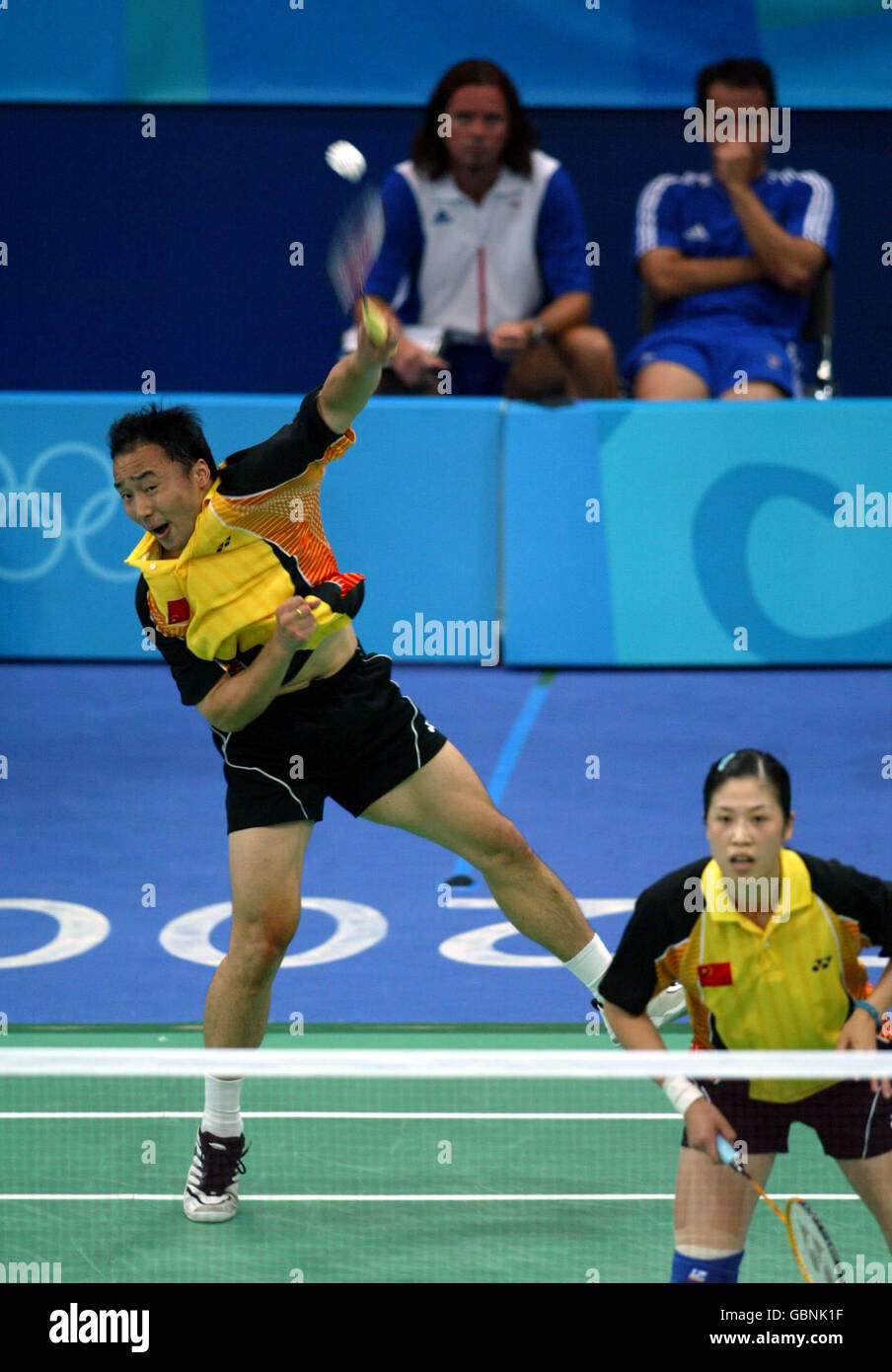 Badminton - Athens Olympic Games 2004 - Mixed Doubles - Final. China's Jun Zhang stretches high for a smash against Great Britain's Nathan Robertson and Gail Emms Stock Photo