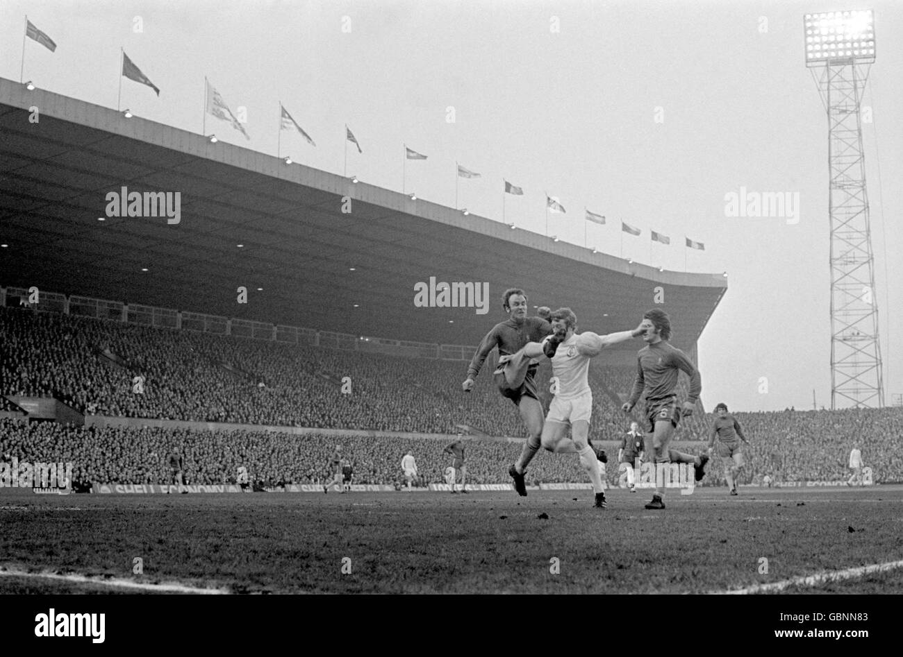 Chelsea's John Dempsey (l) clears from Leeds United's Mick Jones (c) as teammate Dave Webb (r) looks on Stock Photo