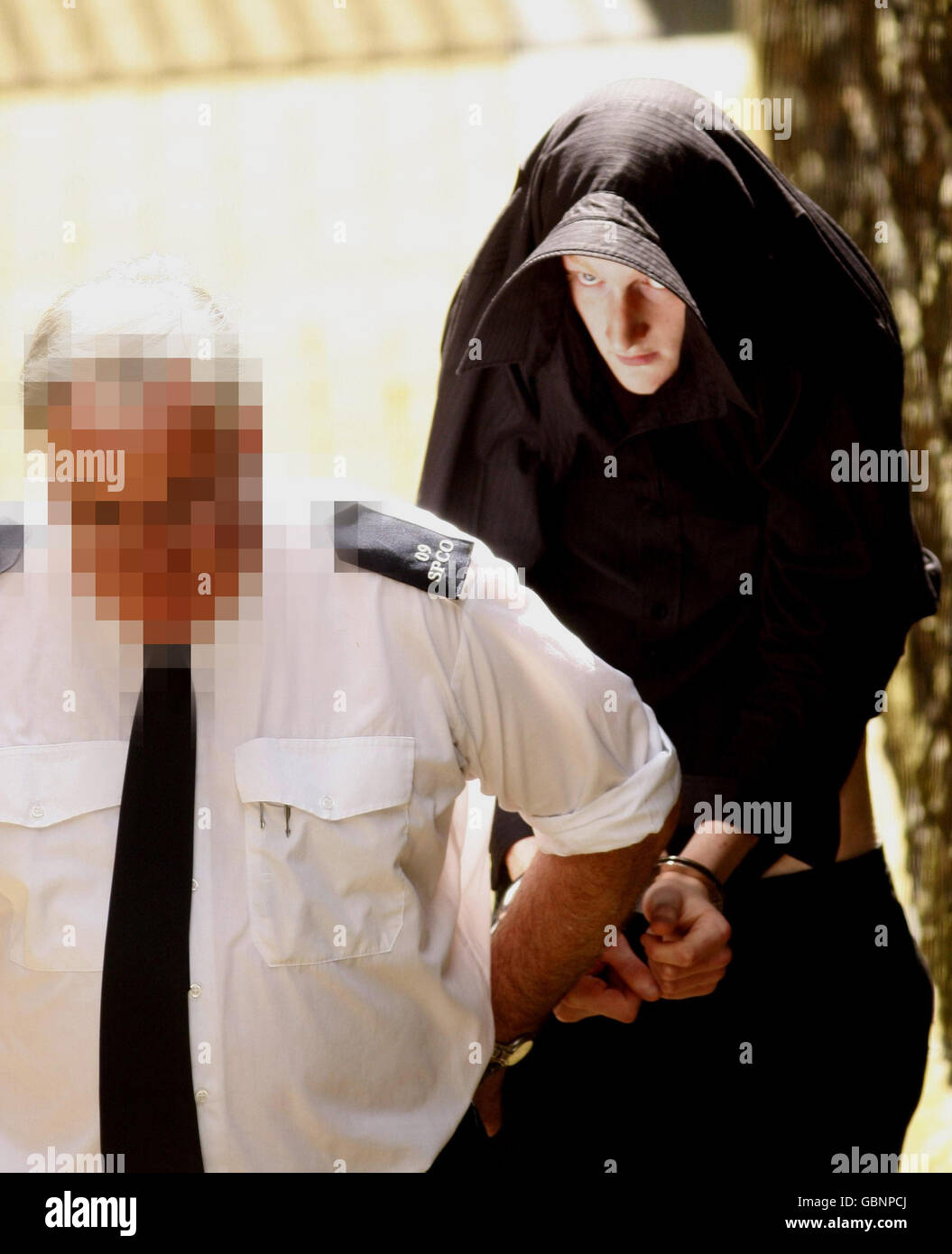 David Craig Cochraine is led away from Ballymena Court in Northern Ireland after he appeared in connection with the murder of Kevin McDaid. Stock Photo