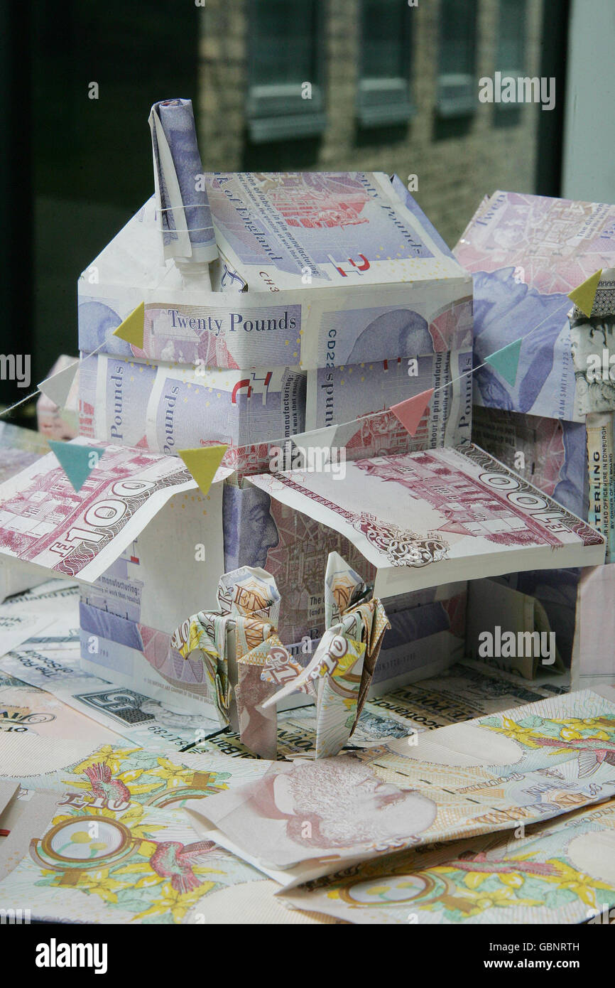 A rural village made out of English, Northern Irish and Scottish pound notes in London by professional origami artist Mark Bolitho. The model was made to celebrate the launch of Village SOS - a new UK wide initiative from Big Lottery Fund (BIG) and BBC ONE designed to help rural villages rejuvenate their communities through starting up new local business ventures. Stock Photo
