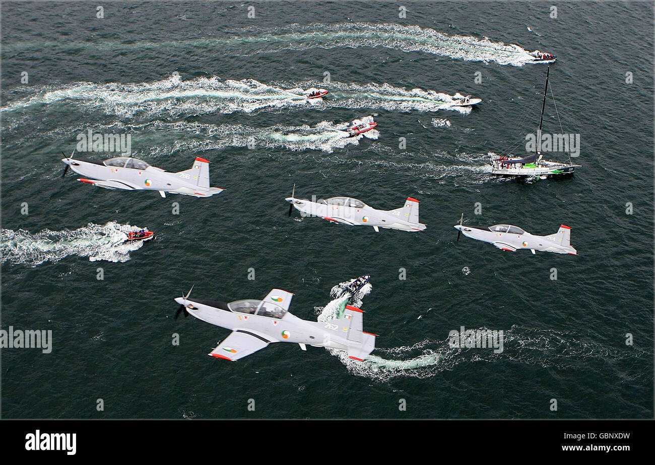 Irish aircorps PC-9 aircraft fly over the Green Dragon taking part in the Volvo Ocean Race after leaving Galway harbour after a two week stop over. Stock Photo