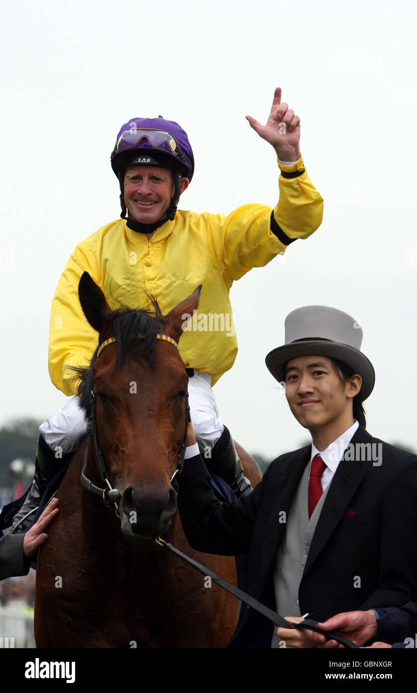 Sea the Stars ridden by Mick Kinane with owner Christopher Tsui after winning The Investec Derby during The Investec Derby Day at Epsom Racecourse, London. Stock Photo