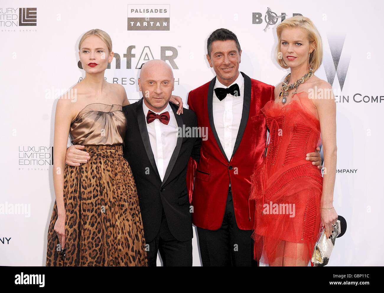 (L-R) Natasha Poly, Domenico Dolce, Stefano Gabbana and Eva Herzigova arriving for the AmfAR 'Cinema Against AIDS' dinner and auction at the Hotel Du Cap, Eden Roc, Cap d'Antibes, Cannes, France Stock Photo