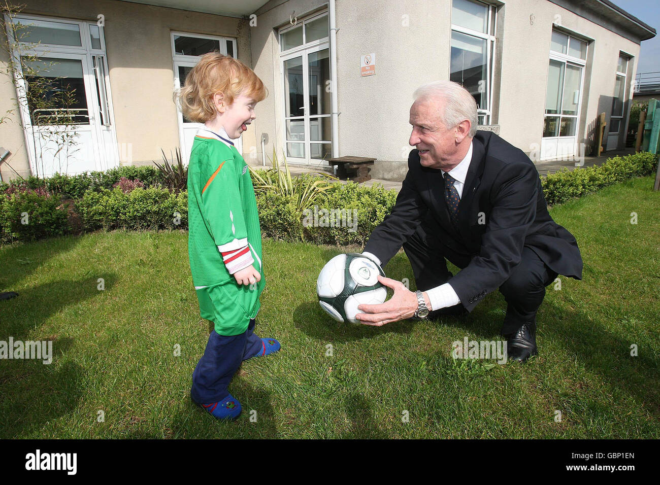 Jamie Shannon (3 years of age) from Wicklow kicks a ball around with Ireland manager Giovanni Trapattoni. Stock Photo