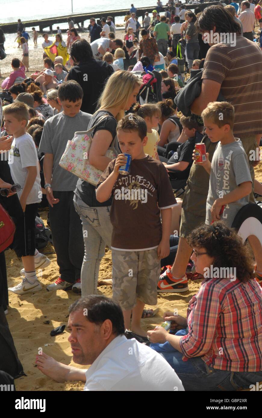 A boy (name not known) drinks from a can at Southend beach during the Southend Festival of the Air 09. The two day event regularly attracts over half a million people to the seafront over the weekend. Stock Photo