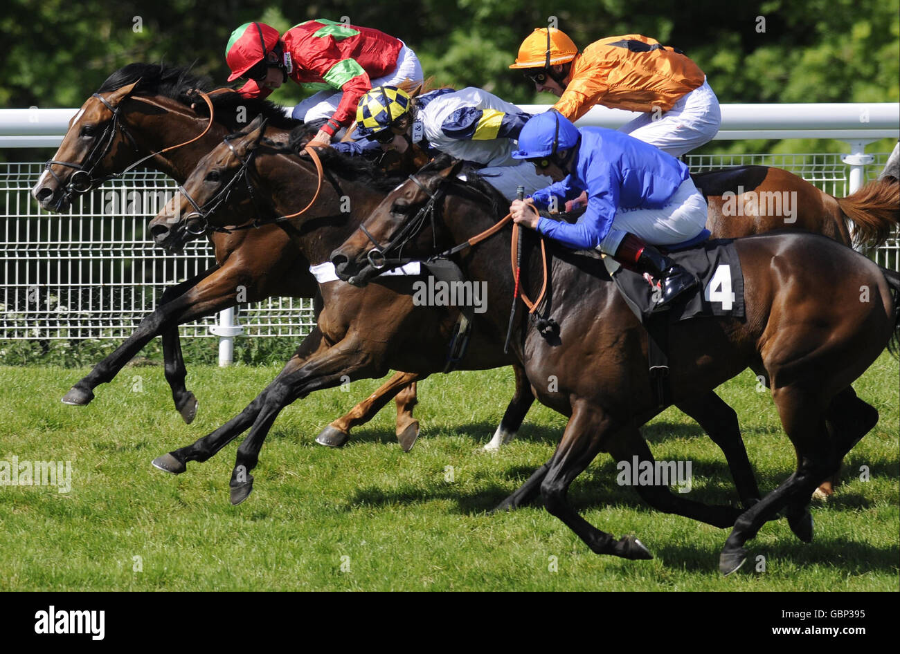Premio Loco and George Baker (orange cap) squeeze through late on to win The On The House Stakes from Pure Poetry and Richard Hughes (left) at Goodwood Racecourse. Stock Photo