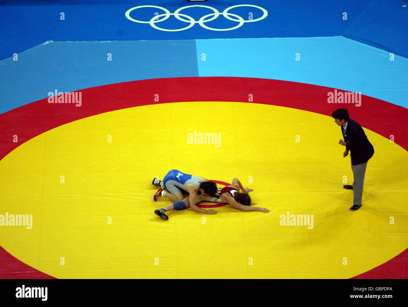 Wrestling - Athens Olympic Games 2004 - Women's 63 KG - Final. Generic view of a Women's Wrestling Match, as the referee takes a close look Stock Photo