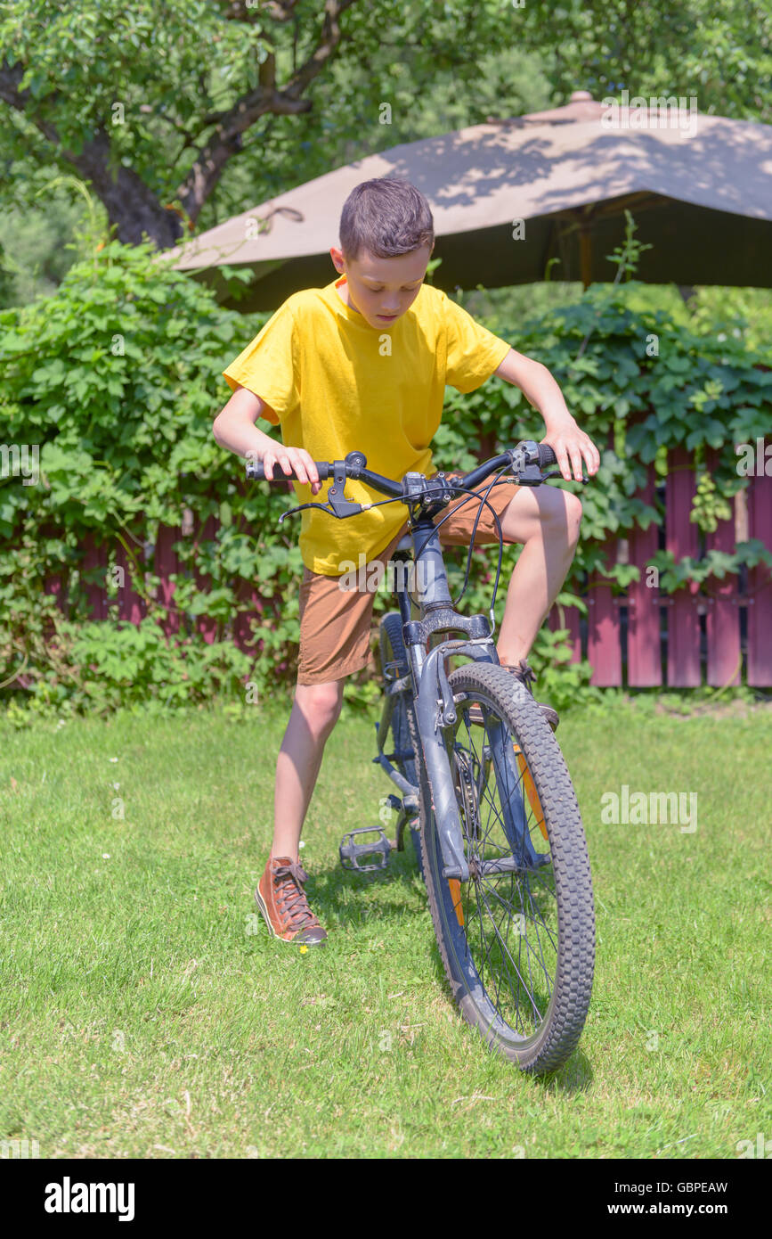 boy on bike in summer day Stock Photo