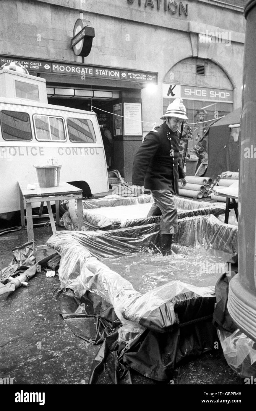 A fireman stepping through antiseptic tanks after working in the tunnel at Moorgate Underground Station where rescuers are still trying to recover bodies of victims of the train disaster. Conditions in the tunnel are so bad that rescuers have been warned to report even small scratches so they can be given anti-tetanus injections. Stock Photo