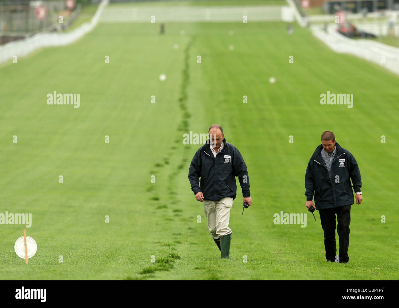Epsom Racecourse clerk of the course Andrew Cooper (left) checks the track during Breakfast with the Stars at Epsom Racecourse. Stock Photo