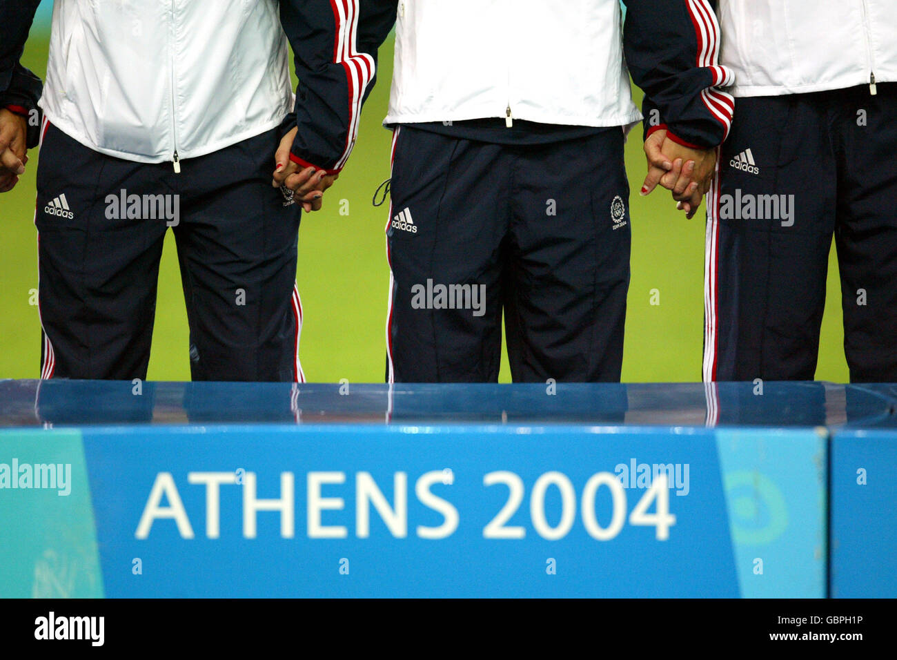Soccer - Athens Olympic Games 2004 - Women's Final - USA v Brazil. The USA team hold hands during the medal ceremony Stock Photo