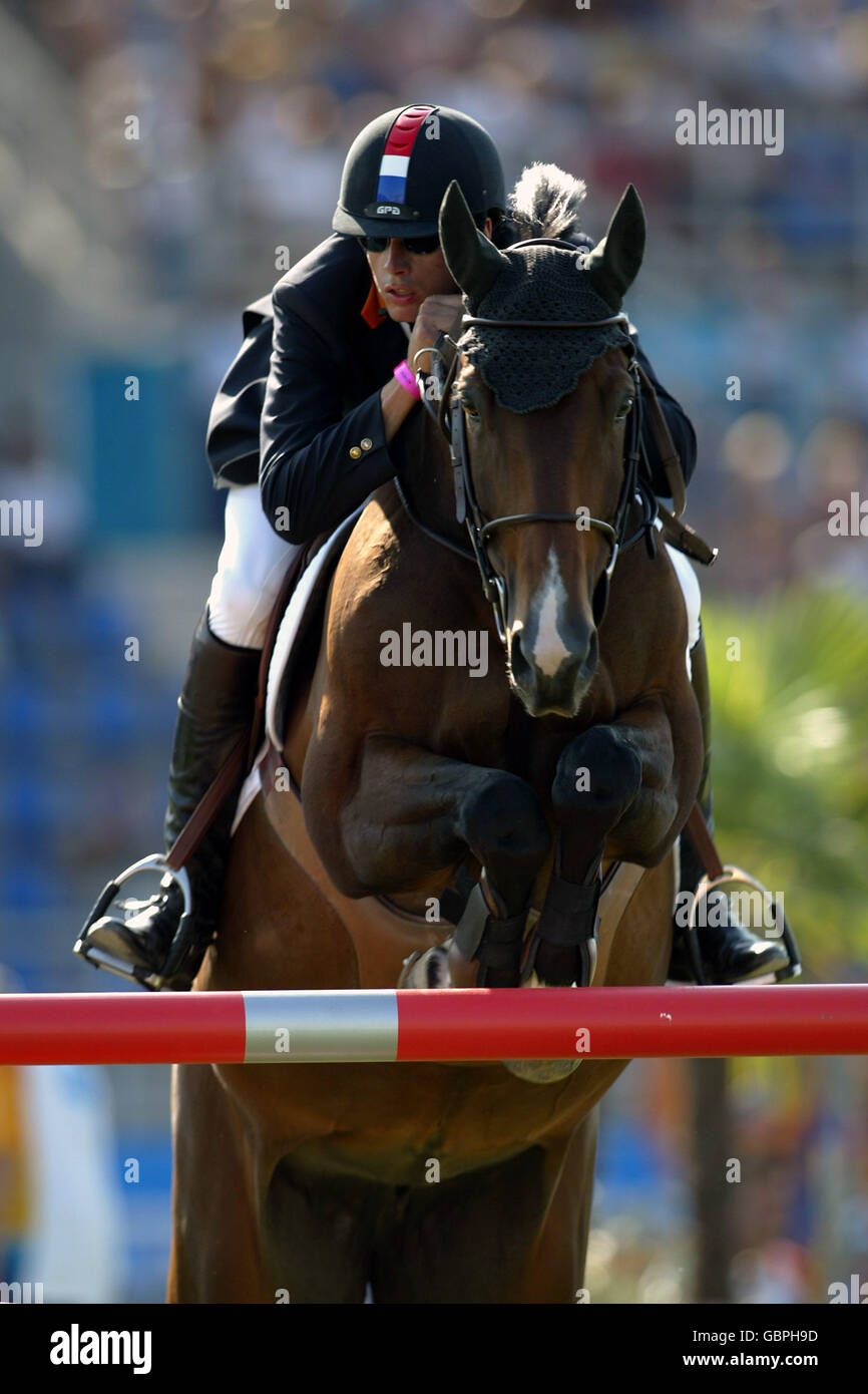 Equestrian - Athens Olympic Games 2004 - Jumping - Individual Round A. The Netherland's Leopold van Asten in action on Fleche Rouge Stock Photo