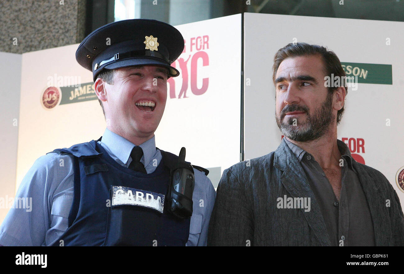 French actor and former soccer player Eric Cantona (left) shares a joke with Garda Richard Horgan as he arrives for the Irish film premiere of 'Looking For Eric' at the lighthouse cinema in Dublin. Stock Photo