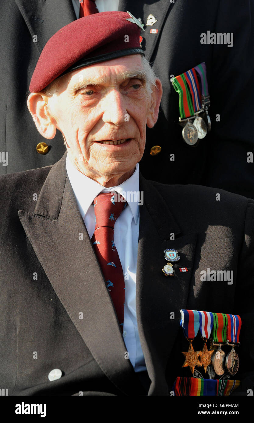 Douglas Baines, 84, of 12th Yorkshire Parachute Regiment, watches a parachute drop by 3 Para at Pegasus Memorial, in Ranville, Normandy, to mark the 65th anniversary of the D-Day landings. Stock Photo