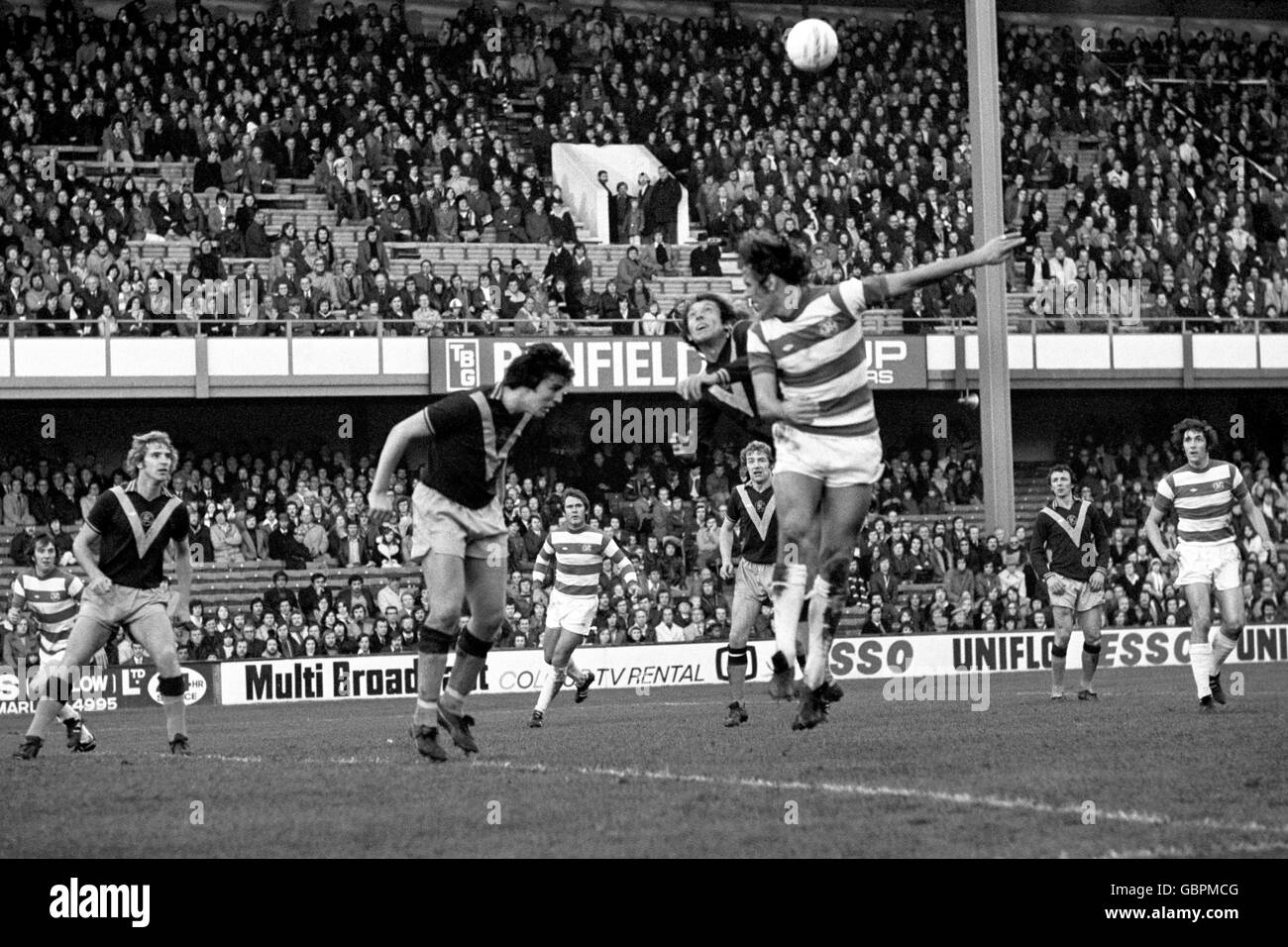 Burnley's Keith Newton (l) parries another QPR attack by heading the ball clear Stock Photo
