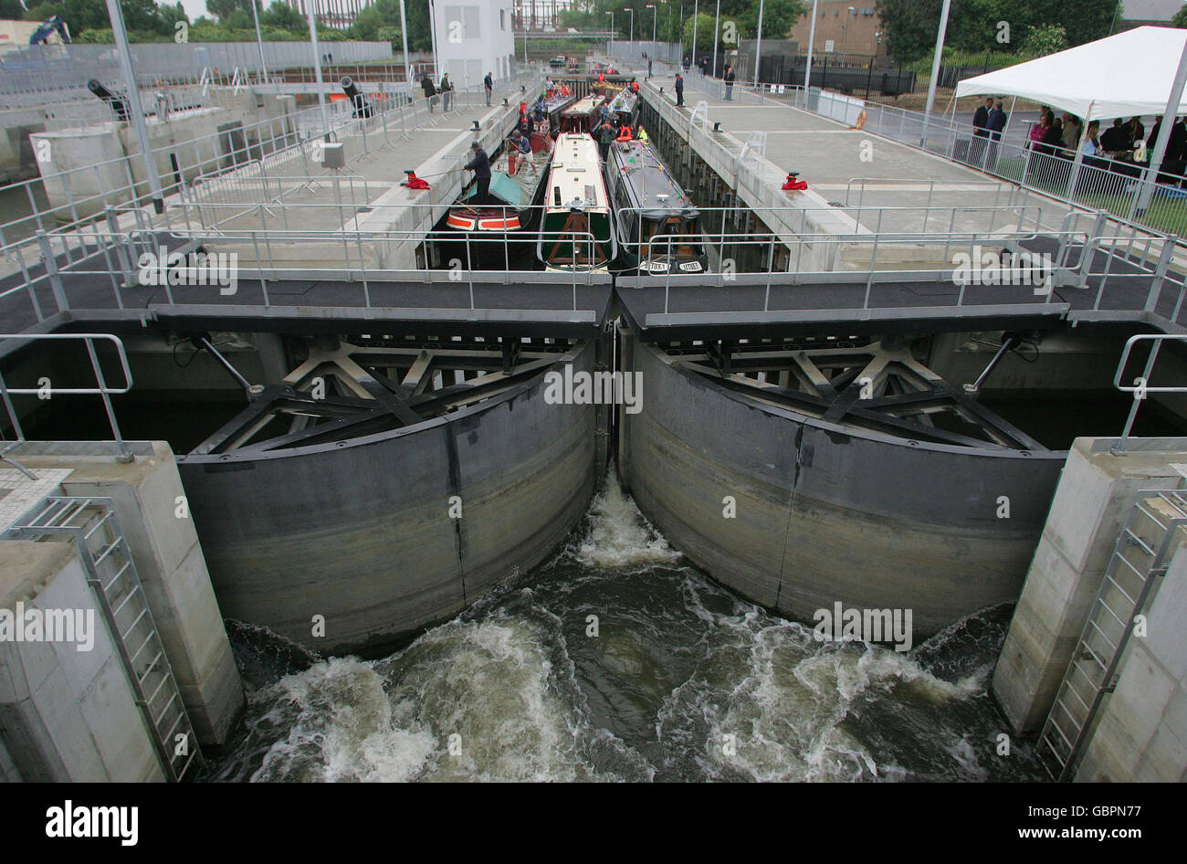 A flotilla of narrow boats are amongst the first vessels to pass through Three Mills Lock in Stratford, east London. Stock Photo