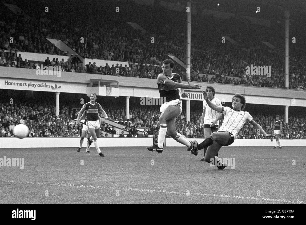 West Ham United's Trevor Brooking scores the first goal despite the attentions of Notts County's David Hunt (r). Also pictured West Ham United's Paul Goddard (l) and Notts County's Rachid Harkouk Stock Photo