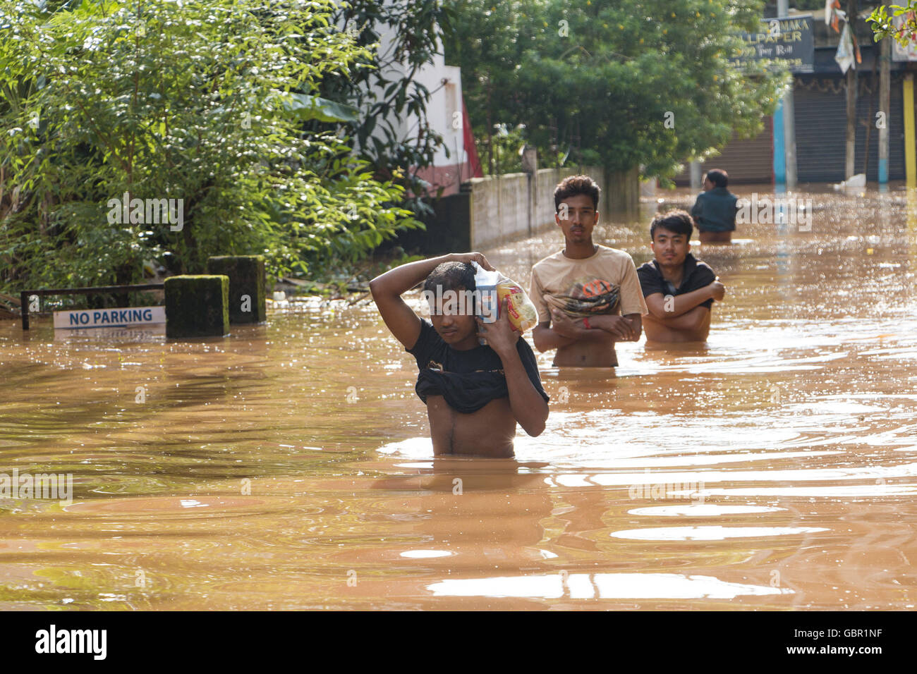 Guwahati, Assam, India. 7th July, 2016. Local people carries home essential commodities in flood affected areas of Guwahati City in Assam, state of India. Due to heavy rain some of the Guwahati city's highly populated areas were submerged by flood waters. Rescue & Relief operation still in progress. Credit:  Vikramjit Kakati India/ZUMA Wire/Alamy Live News Stock Photo