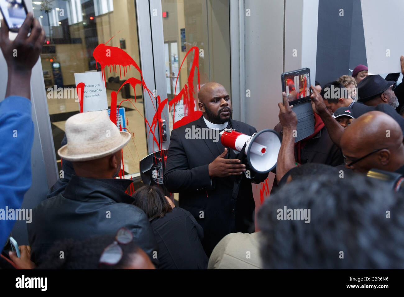 Oakland, California, USA. 7th July, 2016. Protesters pour red paint, symbolizing blood of those killed in police shootings, on the doors of the Oakland Police Department. Credit:  John Orvis/Alamy Live News Stock Photo