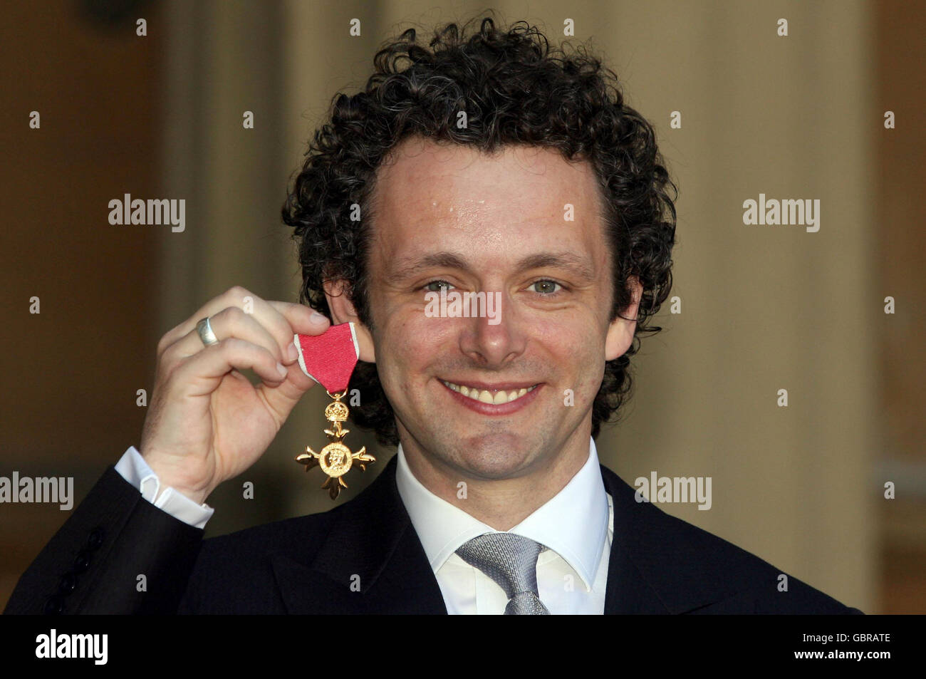 Actor Michael Sheen with the OBE he received earlier from Queen Elizabeth II during investitures at Buckingham Palace. Stock Photo