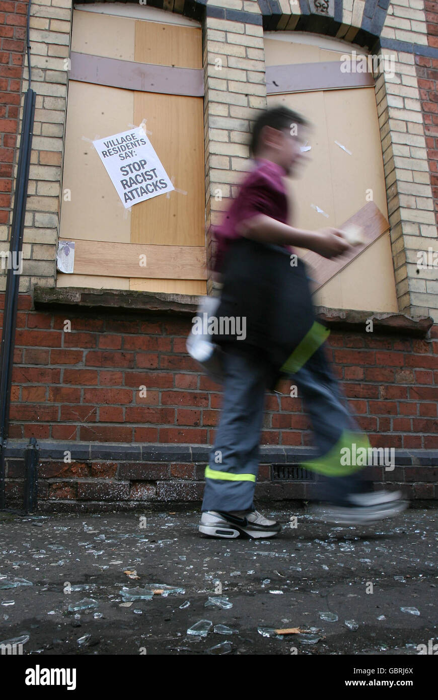 Romanians forced from homes in Belfast. A young boy walks past a property vacated by Romanian refugees after an attack by racists this weekend. Stock Photo