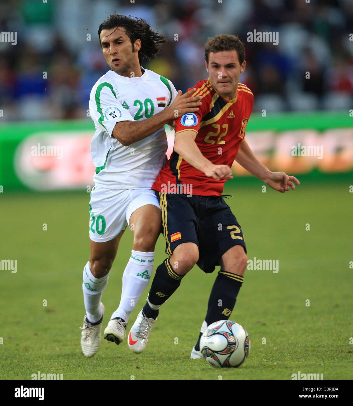 Spain's Juan Manuel Mata and Iraq's Samer Saeed battle for the ball Stock Photo